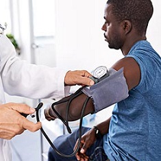 doctor checking patient blood pressure