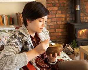 photo of woman holding bowl of soup