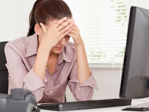 photo of woman holding her head